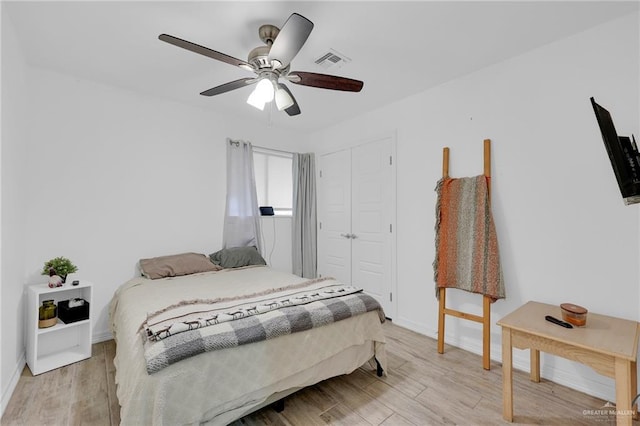 117 W Hawk Ave, Pharr, TX 78577 - bedroom featuring light wood-style floors, a closet, and a ceiling fan