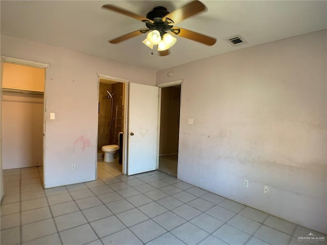3823 Seles Dr, Weslaco, TX 78599 - unfurnished bedroom featuring light tile patterned floors, ensuite bath, ceiling fan, a spacious closet, and a closet