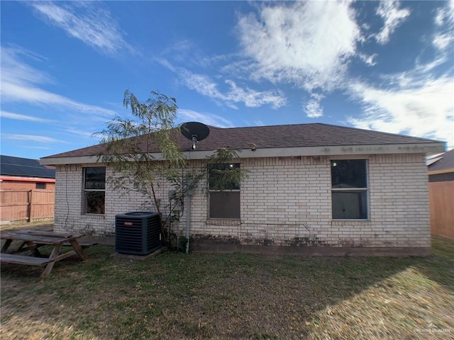3823 Seles Dr, Weslaco, TX 78599 - back of house featuring central AC and a lawn