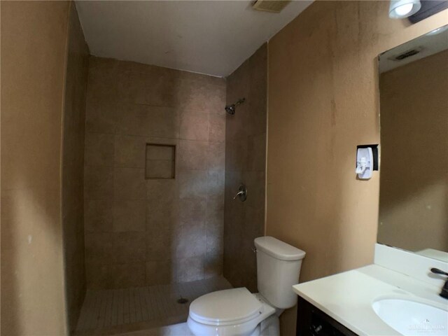 3823 Seles Dr, Weslaco, TX 78599 - bathroom featuring vanity, tiled shower, and toilet