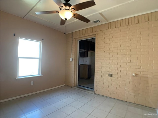 3823 Seles Dr, Weslaco, TX 78599 - spare room featuring brick wall and ceiling fan