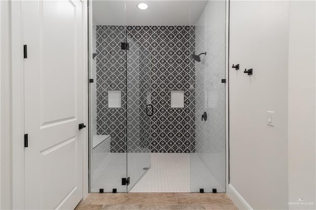 bathroom featuring a shower with shower door