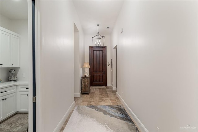 doorway with a chandelier