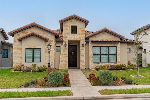 mediterranean / spanish-style home featuring a front lawn