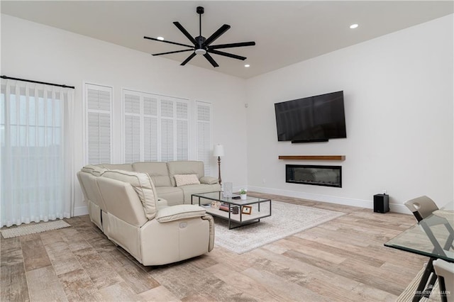 living room with hardwood / wood-style flooring and ceiling fan