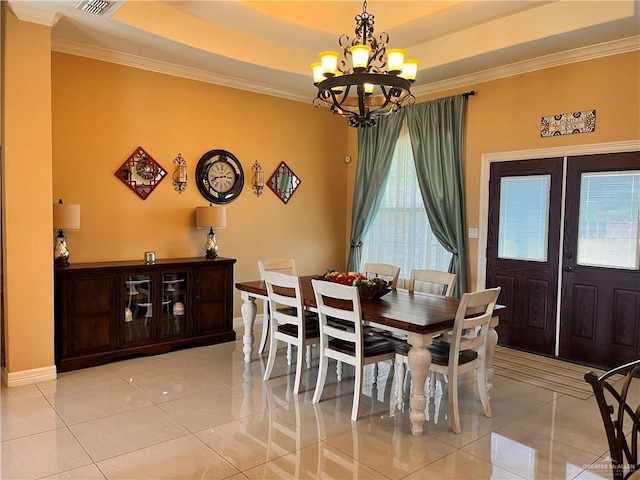917 Beddoes Rd, La Feria, TX 78559 - dining space featuring a chandelier, ornamental molding, light tile patterned flooring, and a raised ceiling