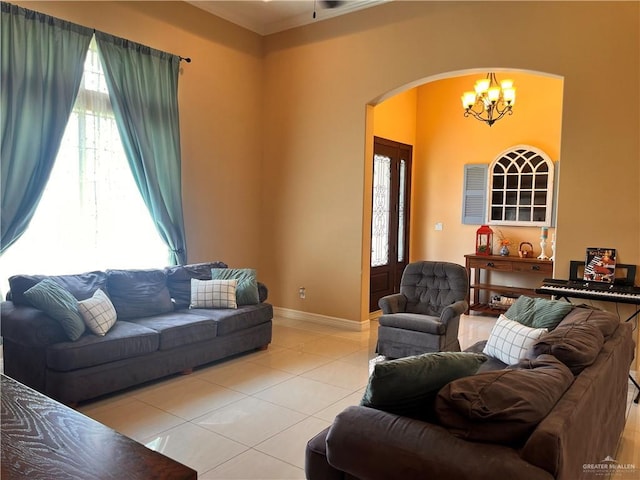 917 Beddoes Rd, La Feria, TX 78559 - living room with arched walkways, light tile patterned floors, and a chandelier
