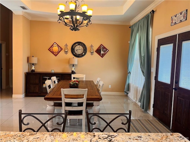 917 Beddoes Rd, La Feria, TX 78559 - dining area featuring light tile patterned flooring, inlaid floor details, a chandelier, a tray ceiling, and french doors