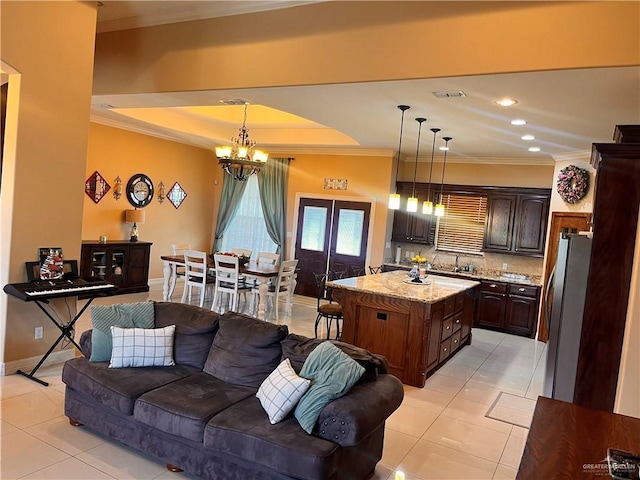 917 Beddoes Rd, La Feria, TX 78559 - kitchen featuring freestanding refrigerator, crown molding, light tile patterned flooring, a chandelier, and dark brown cabinets