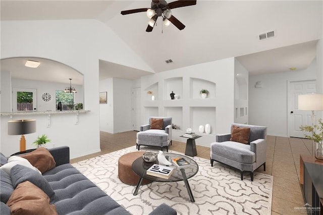 tiled living room with ceiling fan and lofted ceiling