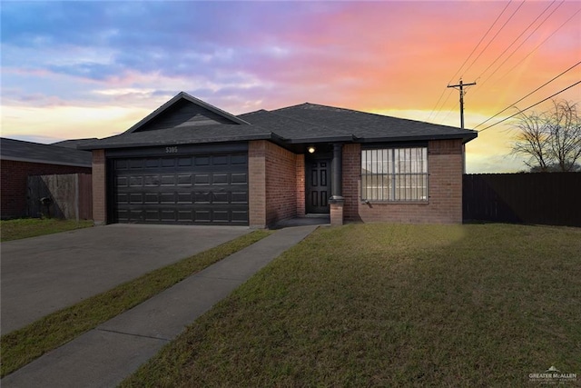 view of front facade featuring a garage and a lawn