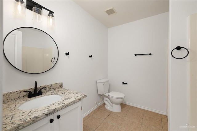 bathroom with tile patterned floors, vanity, and toilet