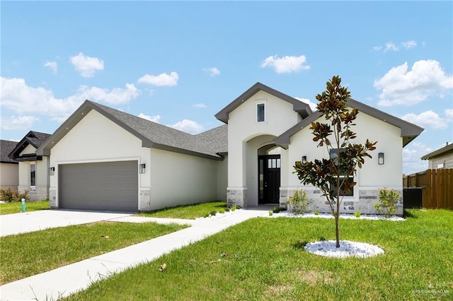 1008 Broken Arrow Dr, Alamo, TX 78516 - view of front of home with a garage, stone siding, stucco siding, and concrete driveway