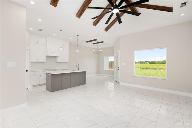 1008 Broken Arrow Dr, Alamo, TX 78516 - kitchen with light countertops, open floor plan, white cabinets, a kitchen island with sink, and recessed lighting