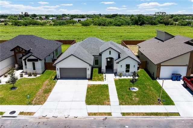 1008 Broken Arrow Dr, Alamo, TX 78516 - view of front of property featuring concrete driveway, an attached garage, stucco siding, a front yard, and roof with shingles