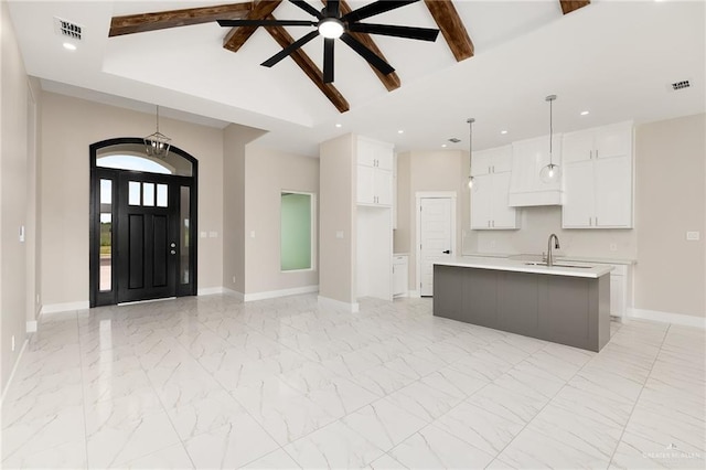 1008 Broken Arrow Dr, Alamo, TX 78516 - kitchen featuring light countertops, white cabinets, beamed ceiling, recessed lighting, and hanging light fixtures