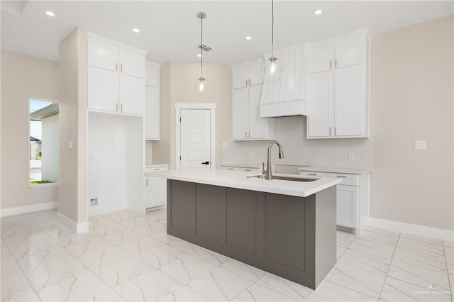 1008 Broken Arrow Dr, Alamo, TX 78516 - kitchen featuring light marble finish flooring, white cabinets, recessed lighting, a center island with sink, and light countertops