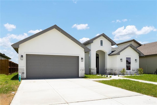 1008 Broken Arrow Dr, Alamo, TX 78516 - view of front of home with stucco siding, stone siding, concrete driveway, and an attached garage