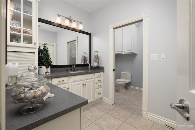 bathroom with tile patterned floors, vanity, and toilet