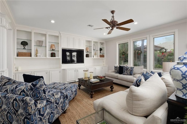 living room featuring ceiling fan and ornamental molding