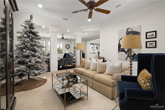 tiled living room featuring ornate columns, ceiling fan, and ornamental molding