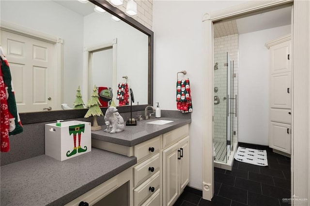 bathroom with tile patterned floors, vanity, and an enclosed shower