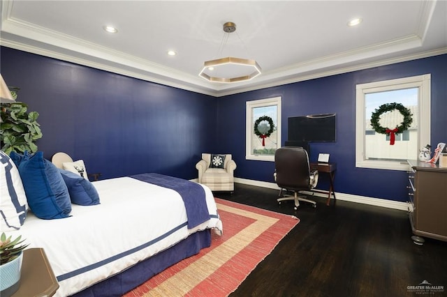 bedroom featuring dark hardwood / wood-style floors, a tray ceiling, and crown molding