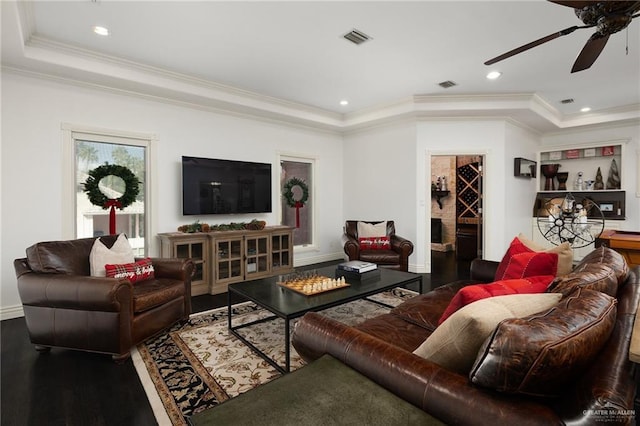 living room featuring hardwood / wood-style flooring, ceiling fan, and ornamental molding