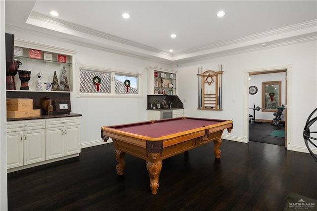 rec room with a raised ceiling, dark hardwood / wood-style flooring, billiards, crown molding, and bar