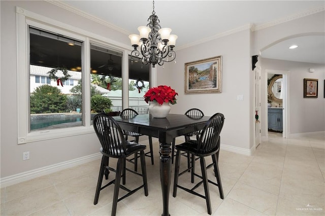 tiled dining area featuring crown molding and a chandelier