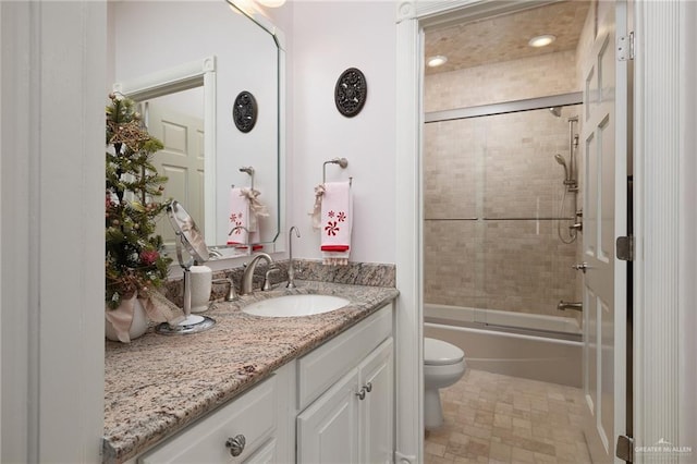 full bathroom with shower / bath combination with glass door, vanity, and toilet