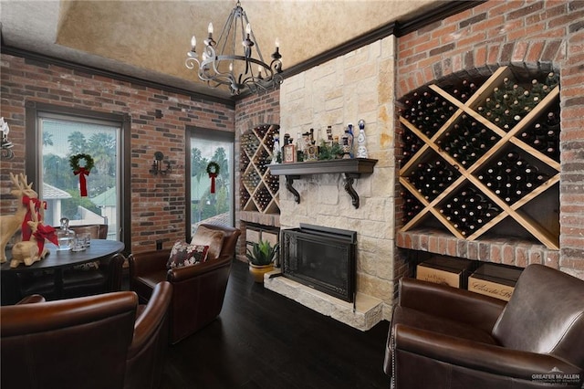 wine cellar with wood-type flooring, brick wall, and a notable chandelier