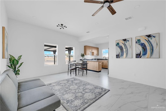 2808 Alpha Rd, Weslaco, TX 78596 - living room featuring light marble finish flooring and ceiling fan
