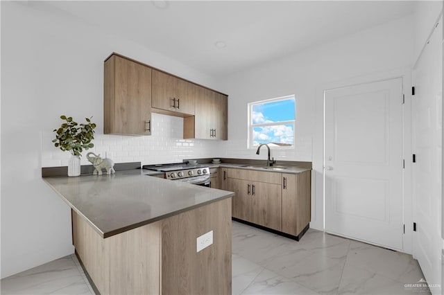 2808 Alpha Rd, Weslaco, TX 78596 - kitchen featuring stainless steel range with electric stovetop, light marble finish flooring, a sink, a peninsula, and decorative backsplash
