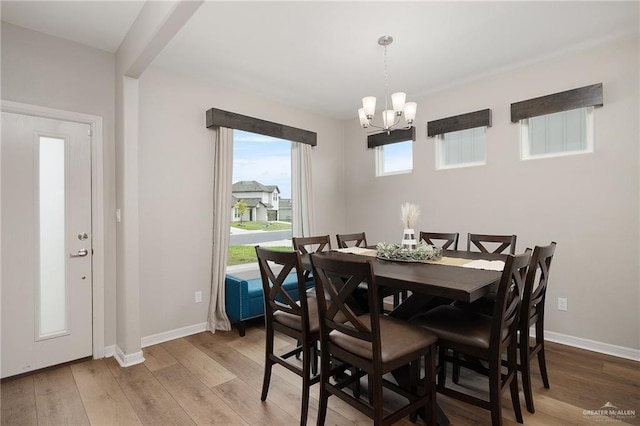 dining area featuring hardwood / wood-style flooring and a notable chandelier