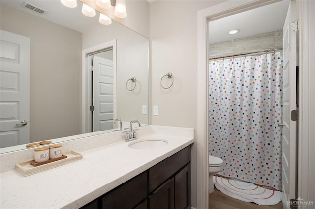 bathroom featuring a shower with curtain, vanity, toilet, and hardwood / wood-style floors