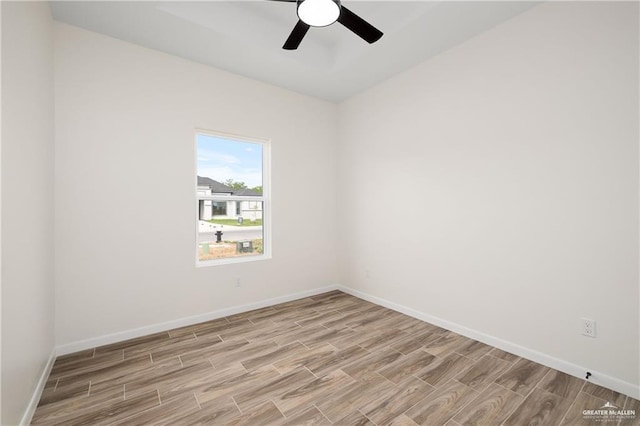 empty room with ceiling fan and light wood-type flooring