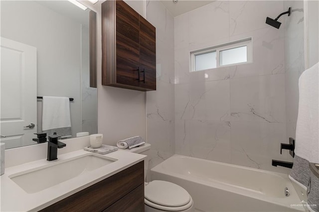 full bathroom featuring vanity, tiled shower / bath combo, and toilet