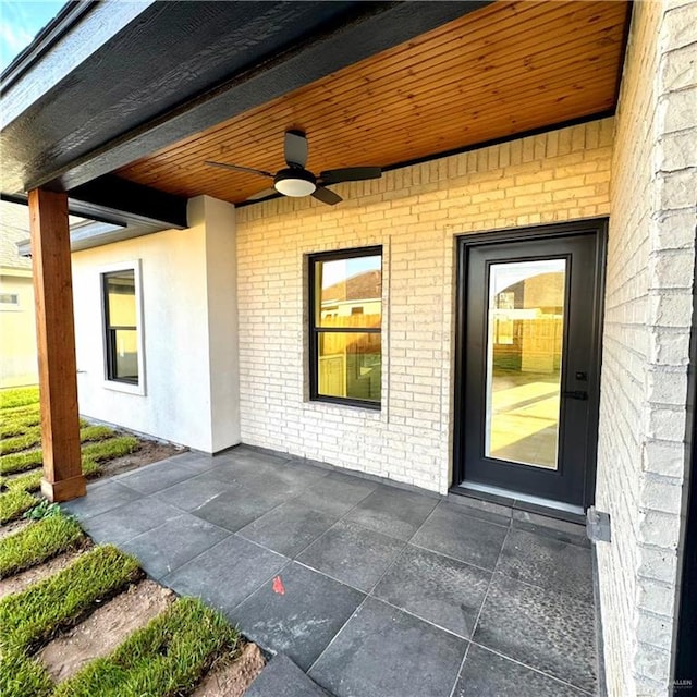 doorway to property with ceiling fan