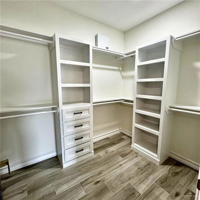 walk in closet with hardwood / wood-style floors