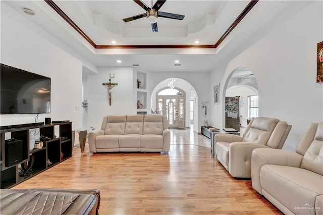 3501 N 39th St, Mcallen, TX 78501 - living area featuring light wood-style flooring, ornamental molding, ceiling fan, arched walkways, and a raised ceiling