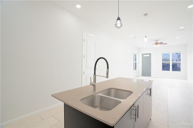 kitchen with recessed lighting, a center island with sink, pendant lighting, a sink, and light tile patterned flooring