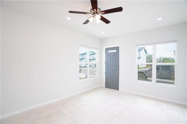 spare room featuring baseboards, recessed lighting, and a healthy amount of sunlight