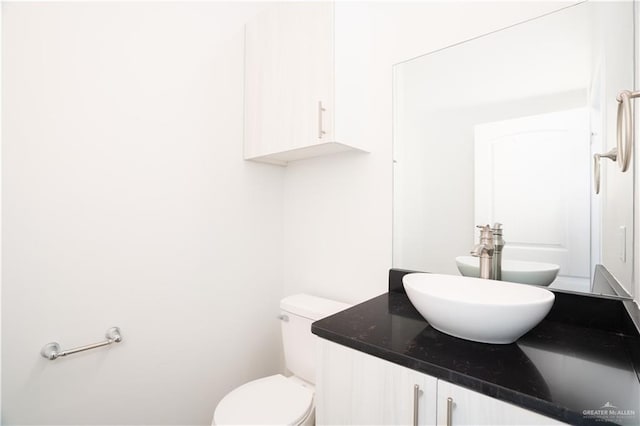 bathroom featuring toilet and vanity