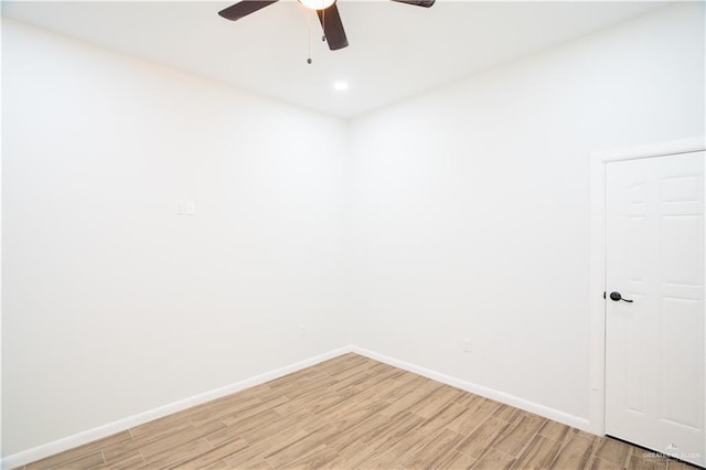 unfurnished room featuring light wood-style floors, baseboards, and a ceiling fan