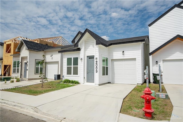 view of front of property featuring an attached garage and concrete driveway