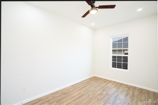 spare room featuring a ceiling fan, recessed lighting, light wood-style flooring, and baseboards