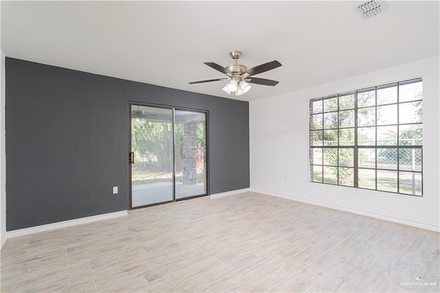 unfurnished room featuring ceiling fan, light hardwood / wood-style flooring, and a healthy amount of sunlight