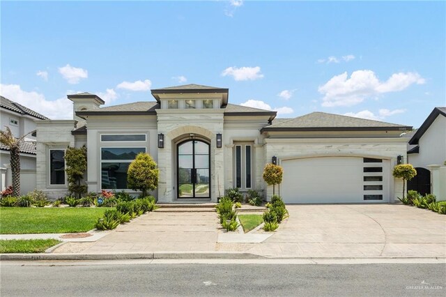 3505 Vendome Dr, Mcallen, TX 78504 - prairie-style home with a garage, driveway, stone siding, and a front lawn