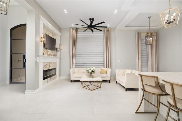 3505 Vendome Dr, Mcallen, TX 78504 - living area with a chandelier, a glass covered fireplace, light tile patterned floors, recessed lighting, and a ceiling fan